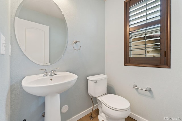 10044 Martin Luther King Blvd, Denver, CO 80238 - half bath featuring baseboards, toilet, a sink, and wood finished floors