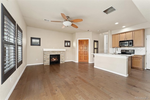 10044 Martin Luther King Blvd, Denver, CO 80238 - kitchen featuring appliances with stainless steel finishes, ceiling fan, open floor plan, dark wood finished floors, and light countertops