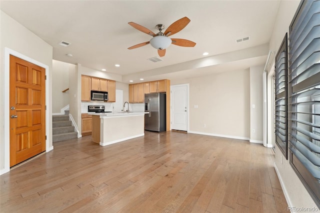 10044 Martin Luther King Blvd, Denver, CO 80238 - kitchen featuring stainless steel appliances, open floor plan, ceiling fan, light brown cabinets, and light countertops