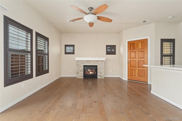 10044 Martin Luther King Blvd, Denver, CO 80238 - unfurnished living room with wood-type flooring, a ceiling fan, a fireplace, and baseboards