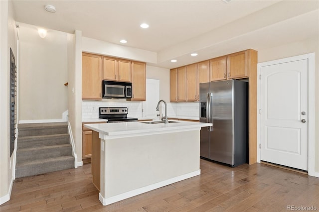 10044 Martin Luther King Blvd, Denver, CO 80238 - kitchen with appliances with stainless steel finishes, a sink, light wood-type flooring, tasteful backsplash, and light brown cabinets