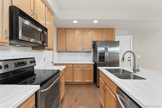 10044 Martin Luther King Blvd, Denver, CO 80238 - kitchen featuring appliances with stainless steel finishes, a sink, recessed lighting, wood finished floors, and light countertops
