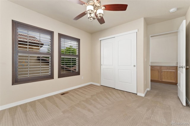 10044 Martin Luther King Blvd, Denver, CO 80238 - unfurnished bedroom with light carpet, baseboards, a closet, and a ceiling fan