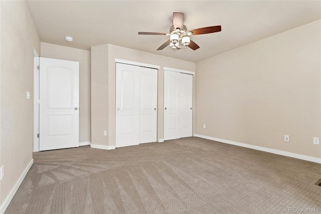 10044 Martin Luther King Blvd, Denver, CO 80238 - unfurnished bedroom with multiple closets, carpet floors, baseboards, and ceiling fan