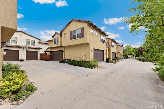 10044 Martin Luther King Blvd, Denver, CO 80238 - view of front of home with a garage, stucco siding, central AC, and driveway