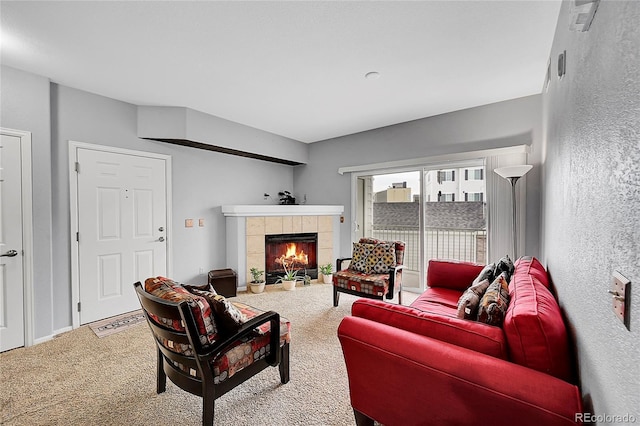 carpeted living room featuring a fireplace