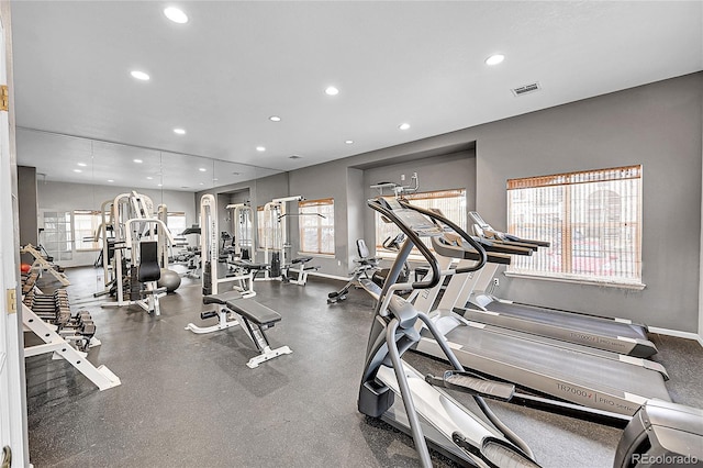 exercise room with recessed lighting, visible vents, and baseboards