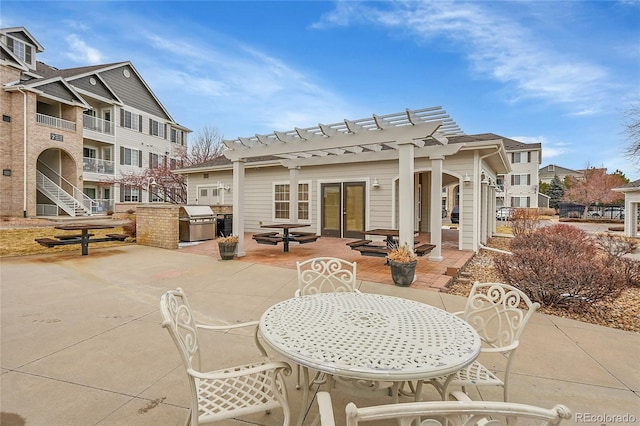 view of patio with outdoor dining space, a grill, area for grilling, and a pergola