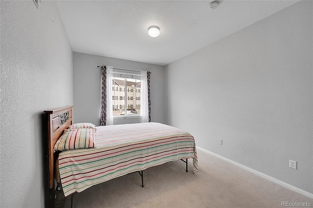 15700 E Jamison Dr Unit 6-201, Englewood, CO 80112 - bedroom featuring baseboards, carpet flooring, and a textured wall