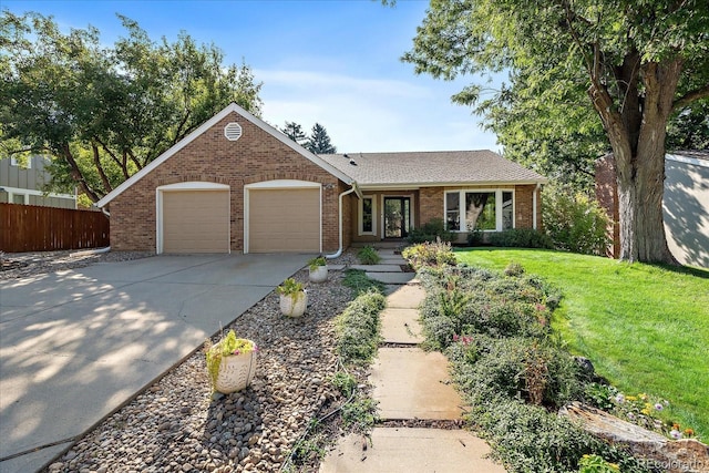 ranch-style home featuring a front lawn and a garage