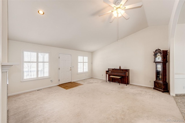 carpeted entryway featuring ceiling fan and lofted ceiling