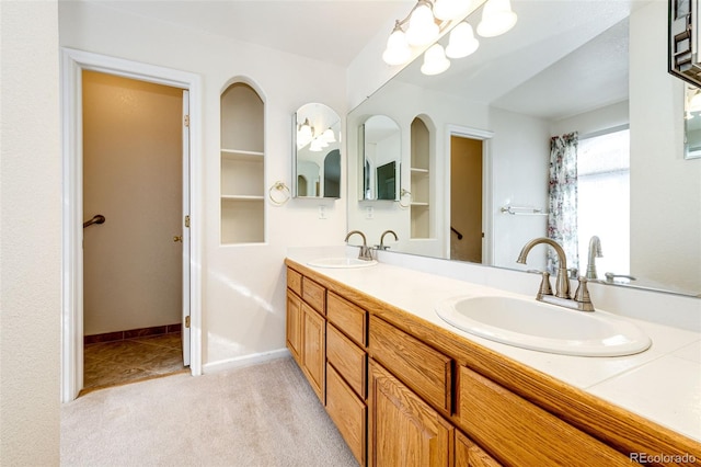 bathroom with vanity and an inviting chandelier