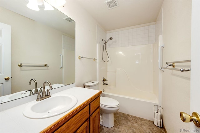 full bathroom featuring tile patterned floors, vanity, tiled shower / bath combo, and toilet