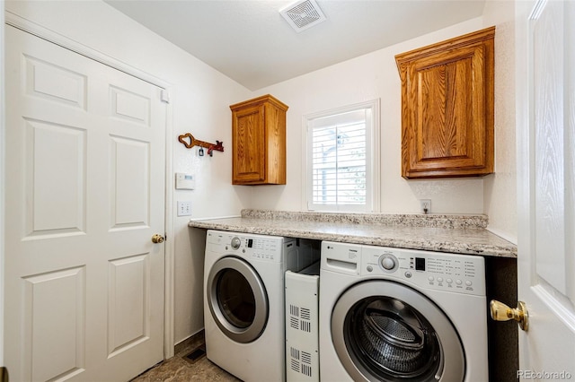 washroom featuring washing machine and dryer and cabinets