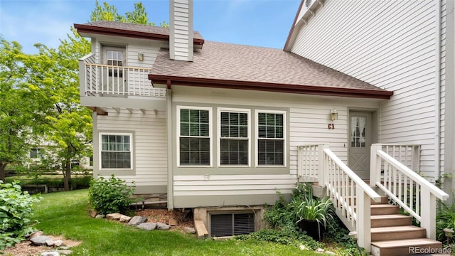 2918 Silverplume Dr Unit C1, Fort Collins, CO 80526 - back of house with a balcony, a lawn, a chimney, and a shingled roof