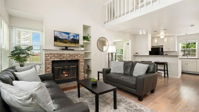 2918 Silverplume Dr Unit C1, Fort Collins, CO 80526 - living room featuring light wood-type flooring, a fireplace, and a high ceiling