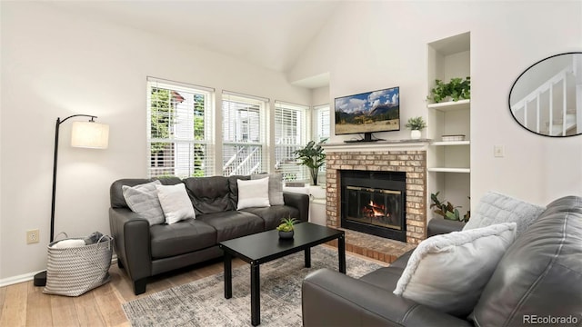2918 Silverplume Dr Unit C1, Fort Collins, CO 80526 - living room featuring wood finished floors, a brick fireplace, and vaulted ceiling
