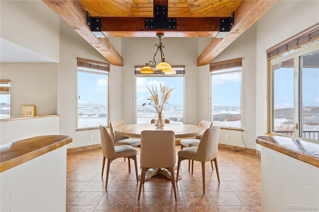 dining area with tile patterned flooring, wooden ceiling, and beam ceiling