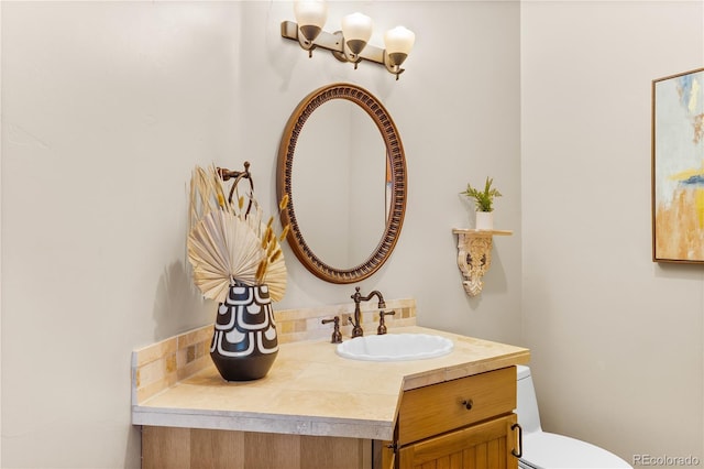 bathroom featuring vanity and toilet