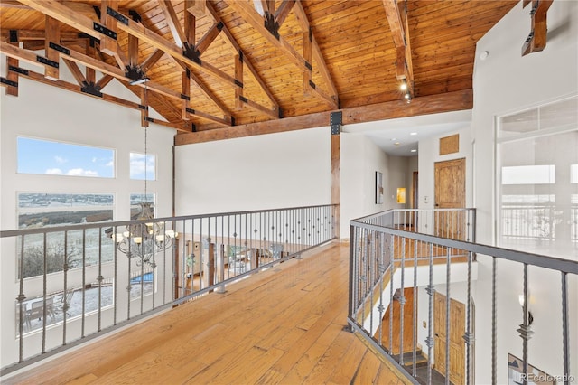 corridor with wood ceiling, a chandelier, high vaulted ceiling, hardwood / wood-style flooring, and beamed ceiling