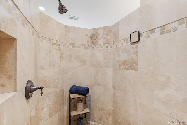 interior details with a tile shower