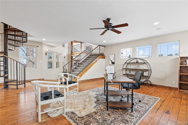 living area with ceiling fan and light wood-type flooring