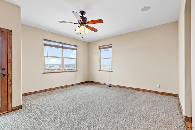 empty room with light colored carpet and ceiling fan