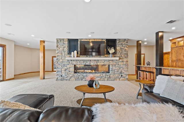 living room with a stone fireplace and light carpet