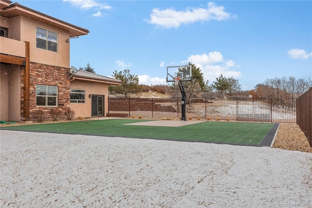 view of basketball court with a yard