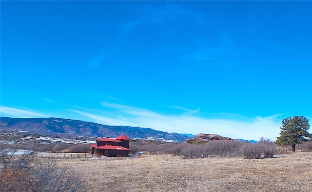 mountain view featuring a rural view