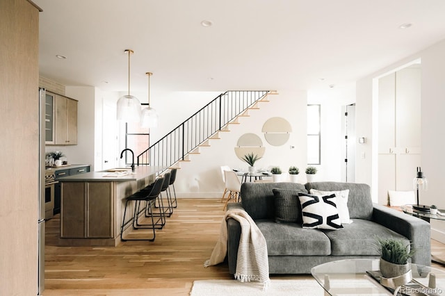 2753 Curtis St, Denver, CO 80205 - living room with stairs, recessed lighting, light wood-style floors, and plenty of natural light