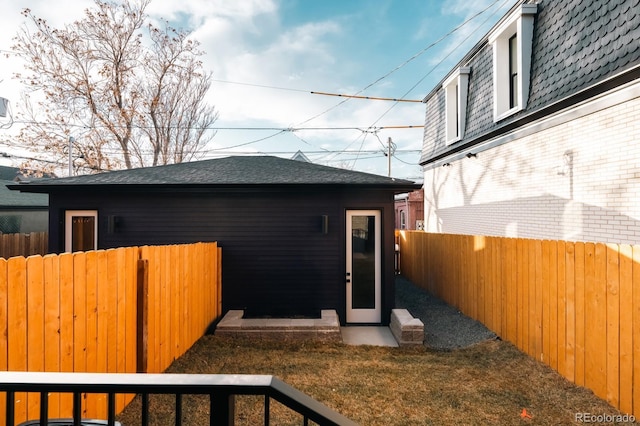 2753 Curtis St, Denver, CO 80205 - exterior space with a fenced backyard, brick siding, and a shingled roof