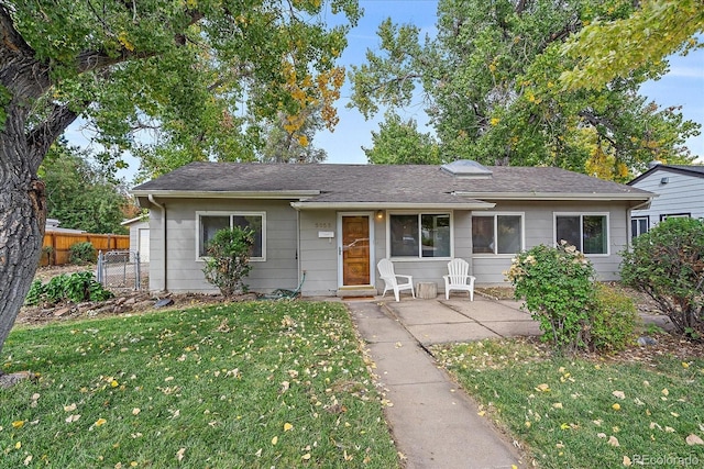 ranch-style house with a front yard and a patio