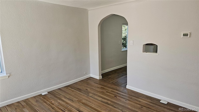 spare room featuring dark hardwood / wood-style floors