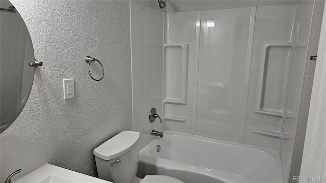 bathroom featuring bathtub / shower combination and toilet