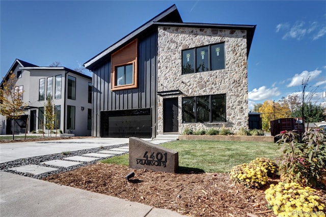 contemporary home featuring a front yard and a garage