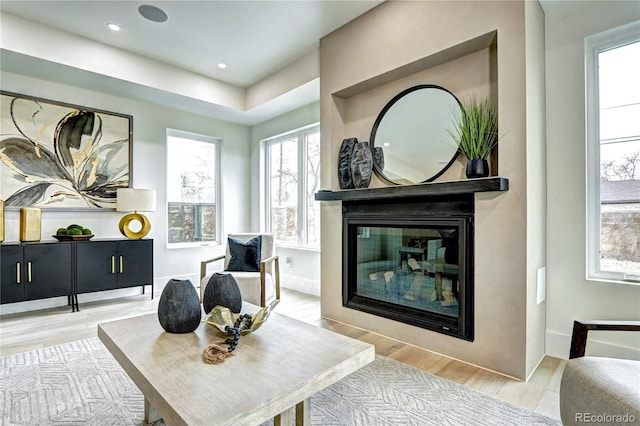 sitting room with a large fireplace and light hardwood / wood-style floors