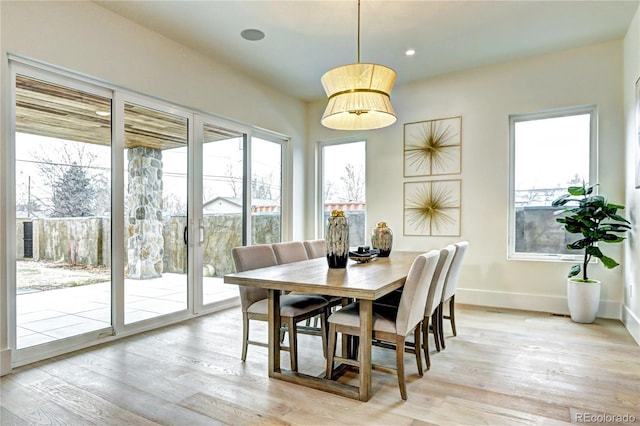 dining space with light hardwood / wood-style flooring and a wealth of natural light