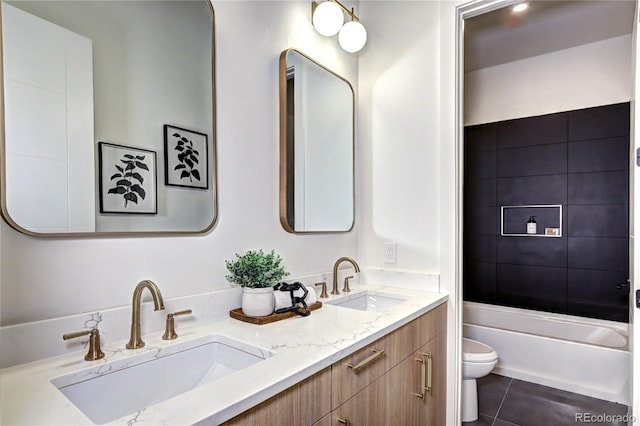 full bathroom with vanity, tile patterned flooring, toilet, and tiled shower / bath