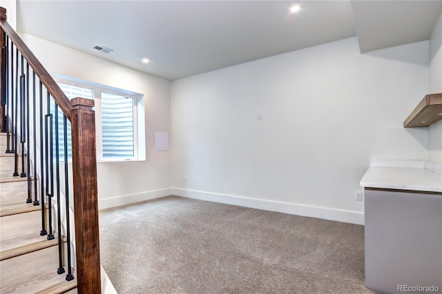 unfurnished living room with light colored carpet