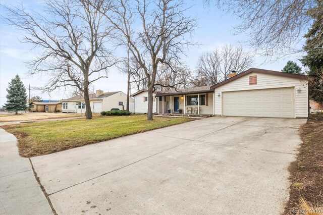 ranch-style house with concrete driveway, an attached garage, a chimney, and a front lawn