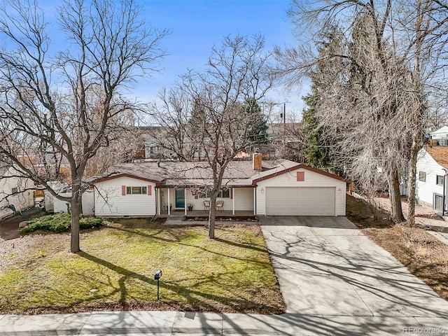 view of front of property featuring an attached garage, driveway, a chimney, and a front yard