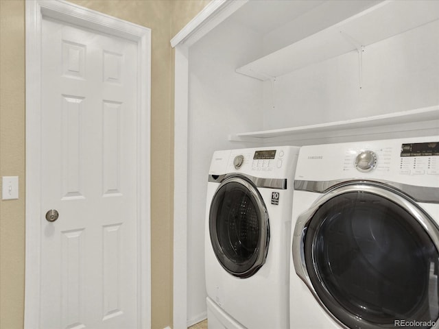 clothes washing area with independent washer and dryer, attic access, and baseboards