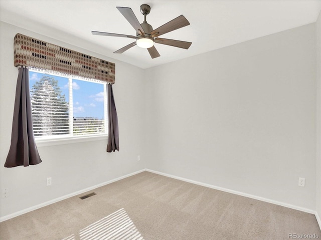 unfurnished room with carpet flooring, baseboards, and ceiling fan