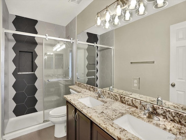 full bath with toilet, a stall shower, and double vanity