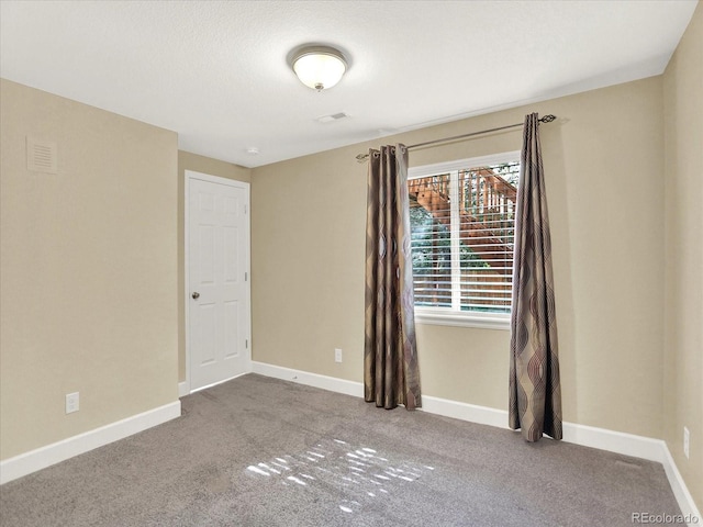 carpeted spare room with baseboards