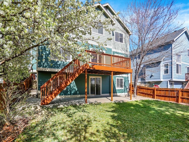 back of property with a patio area, a wooden deck, and stairs