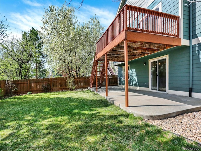 view of yard featuring a patio, a wooden deck, and stairway