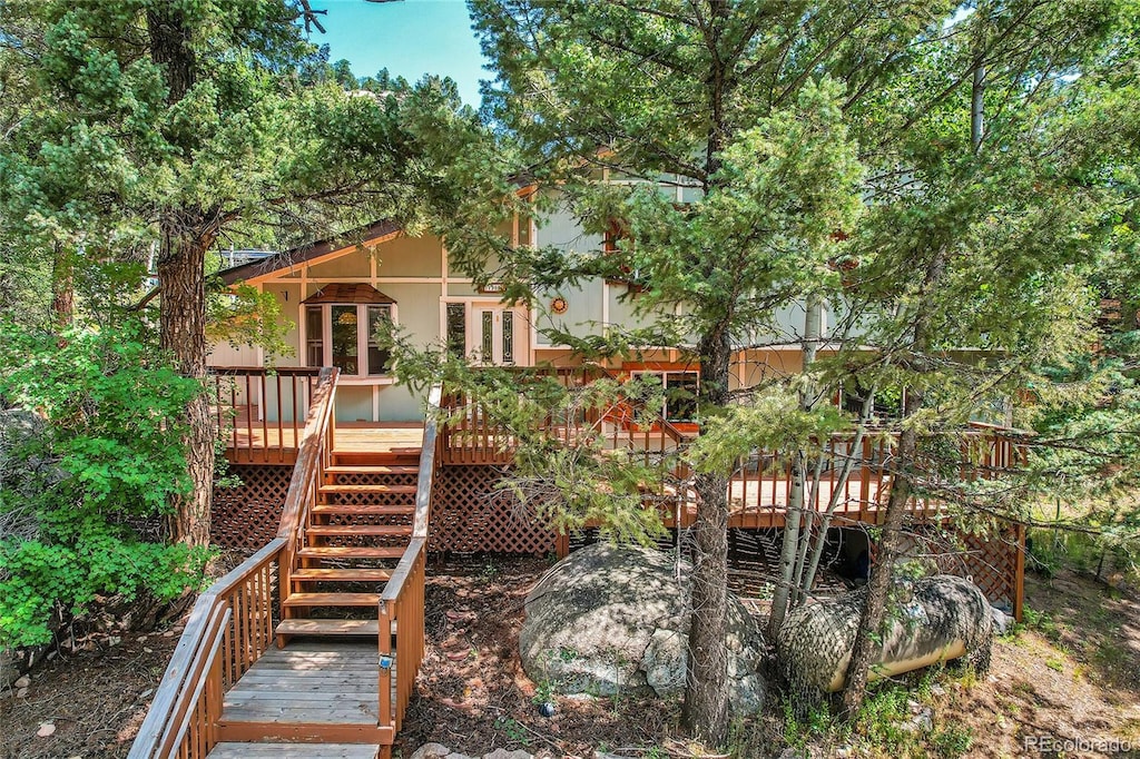 rear view of house with a wooden deck