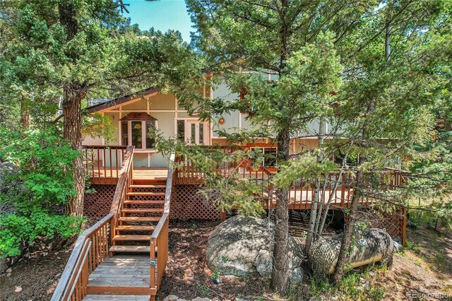 rear view of house with a wooden deck